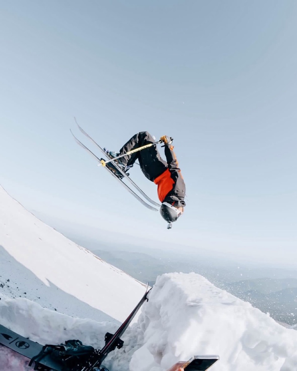 Cooper flipping on skis in red and black