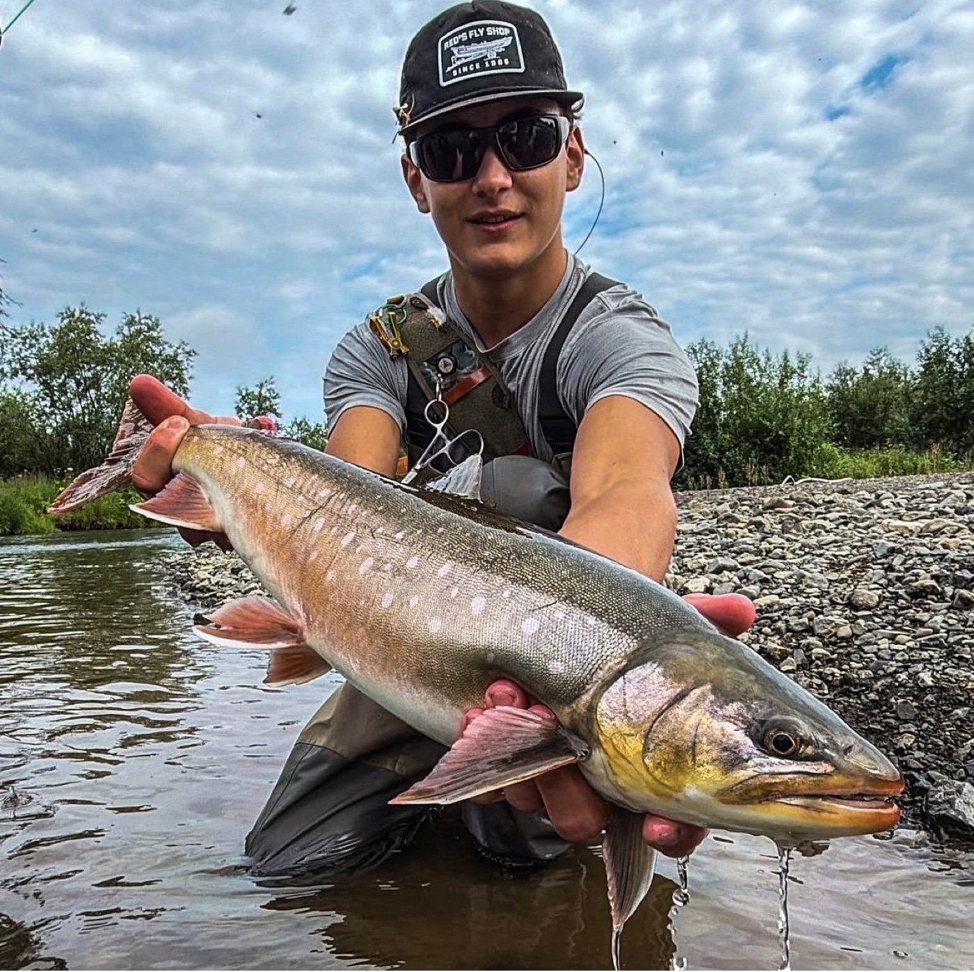 Eli guiding in Alaska with a large fish