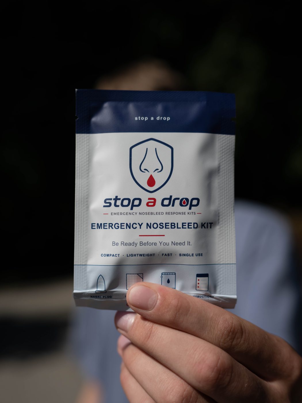 A Stop A Drop founder holding the Single Kit pouch