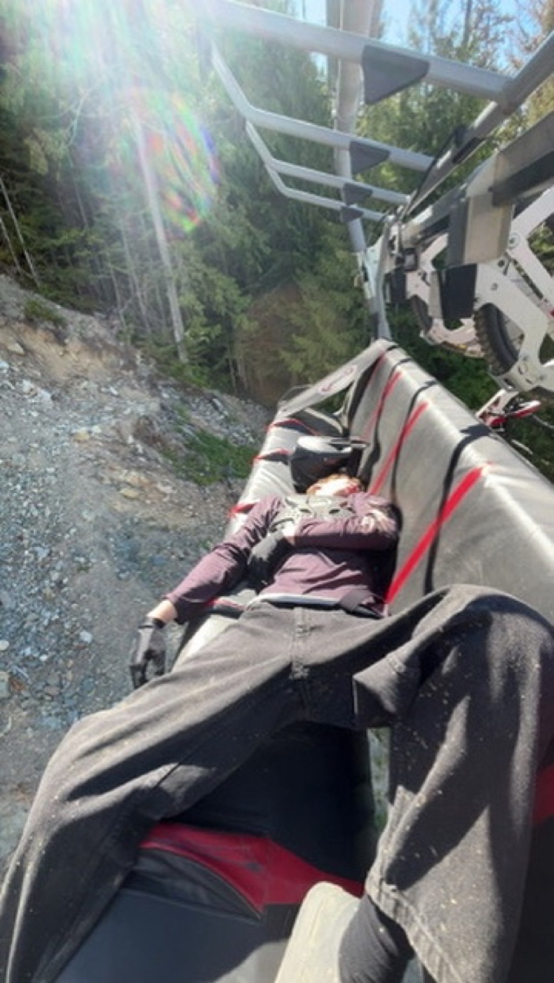 Sam relaxing on a chairlift in the mountains