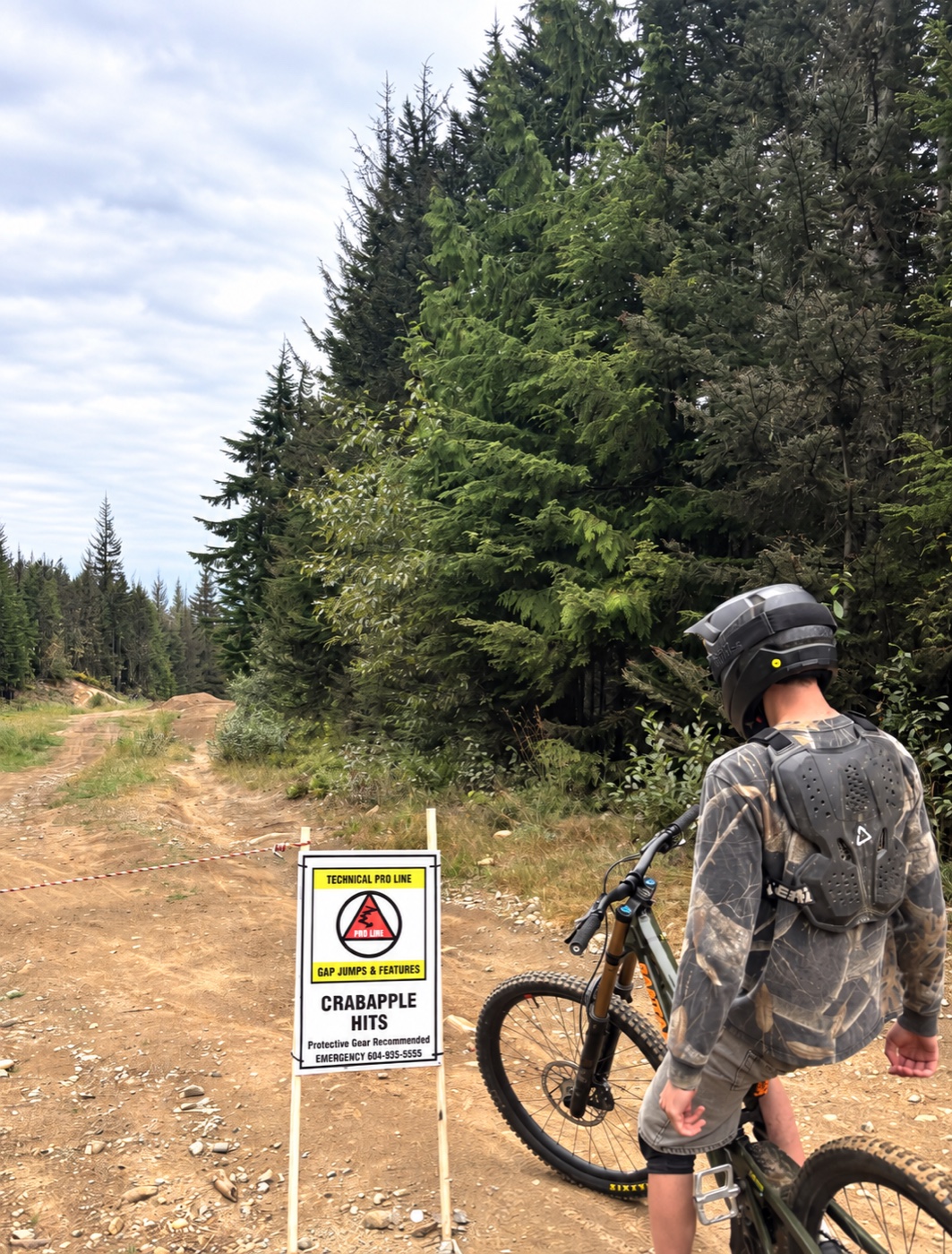 Sam with his mountain bike on a forest trail